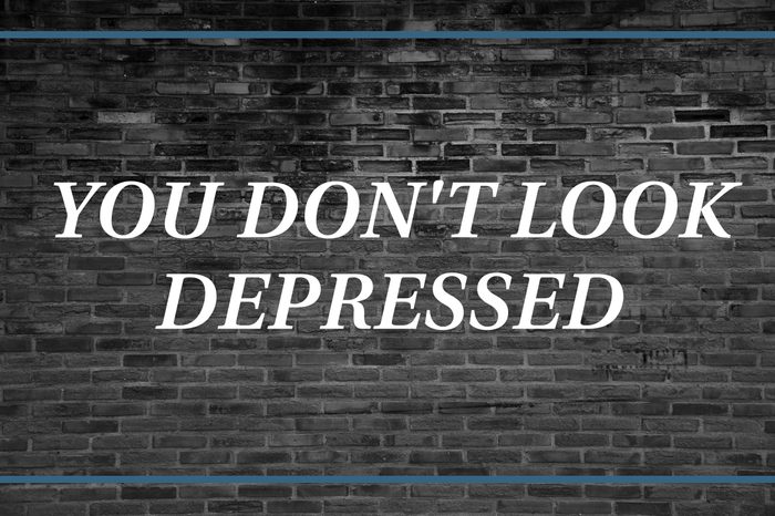 Brick wall background that says: You don't look depressed.