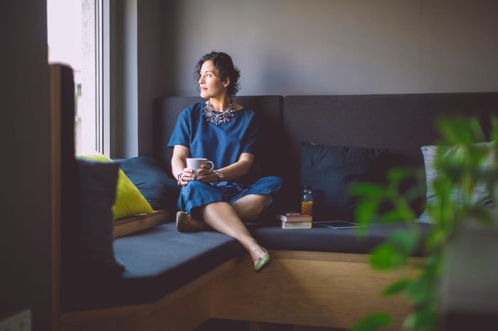 woman reflecting looking out of window