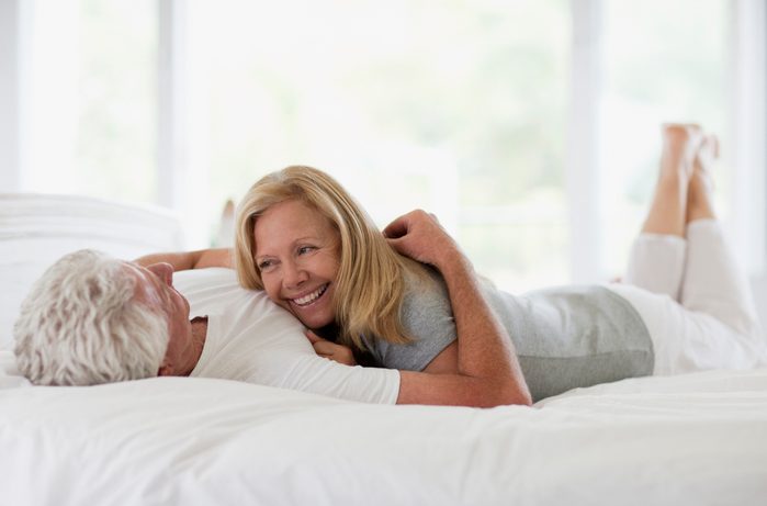 happy couple lying in bed together