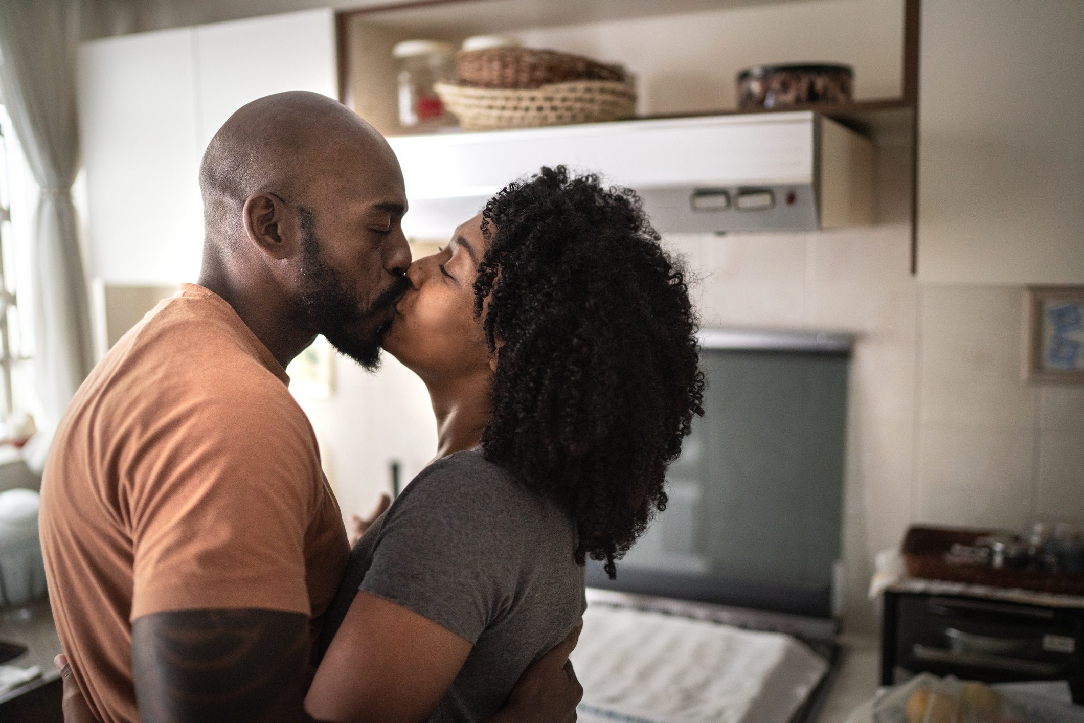 couple kissing at home