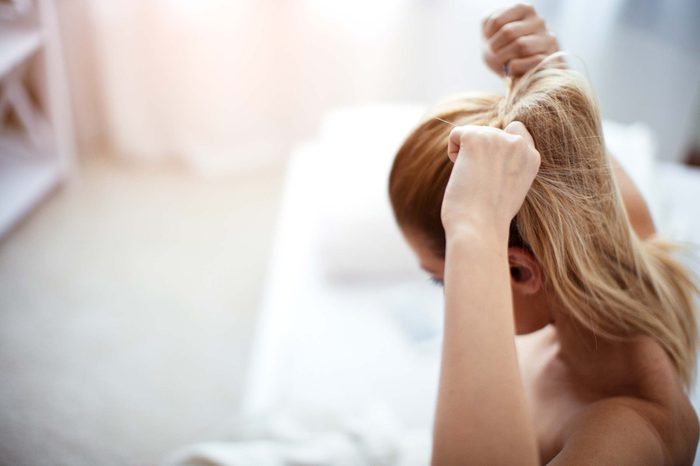 woman fastening a ponytail