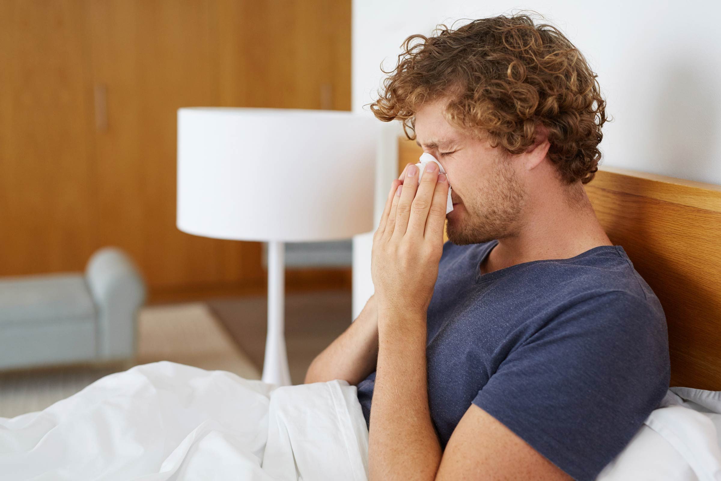 man blowing nose