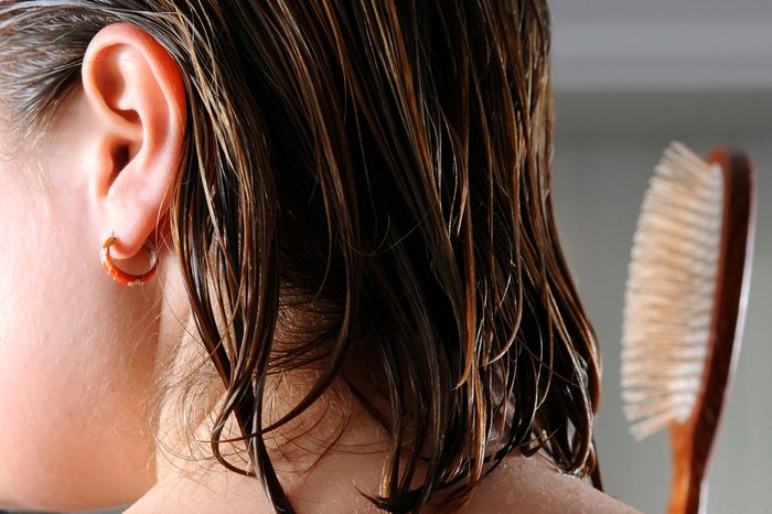 woman brushing wet hair