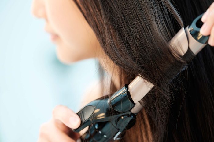 woman using a curling iron