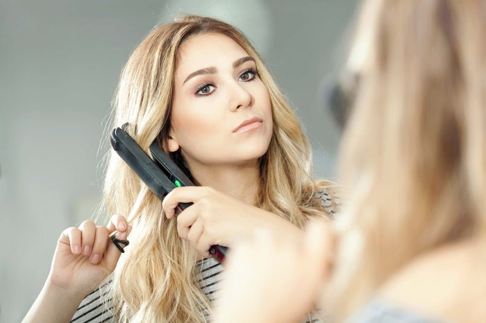 woman using a flat iron