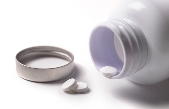 pill bottle with pills on white background