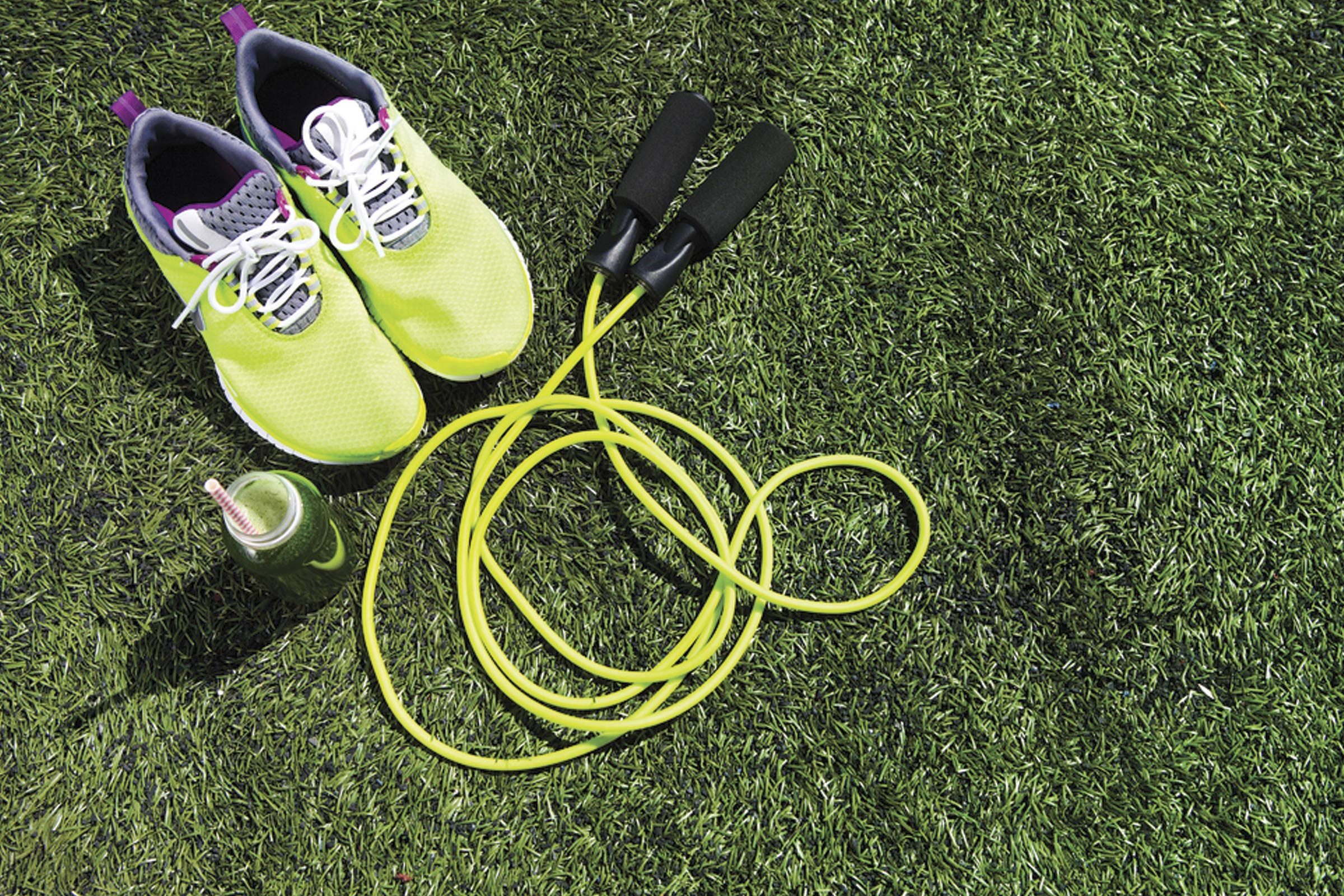 sneakers and a jump rope on grass