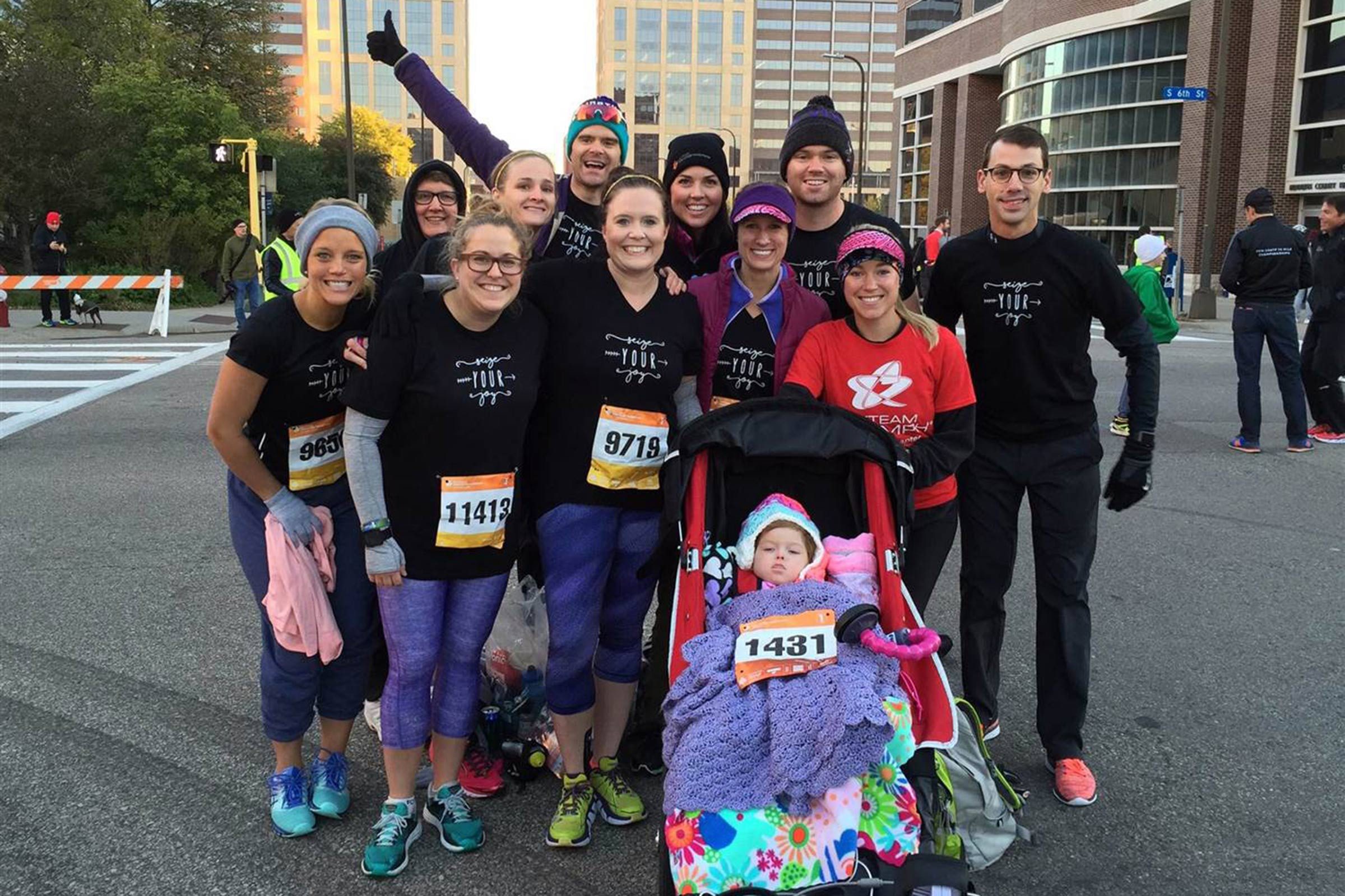 group of friends running with baby charlotte