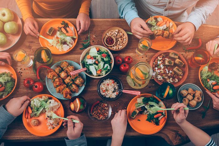 people eating delicious food at table