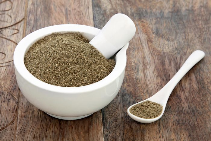 gymnema powder in a mortar and pestle bowl