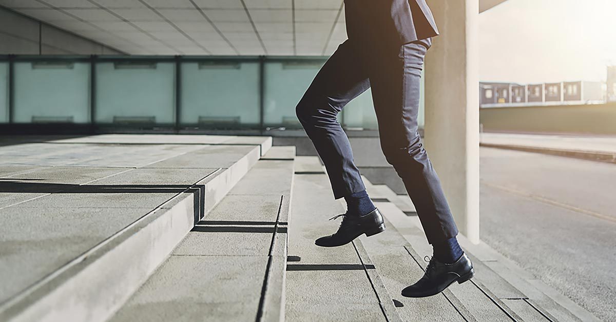 business man running up stairs 