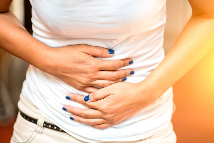 woman clutching her stomach