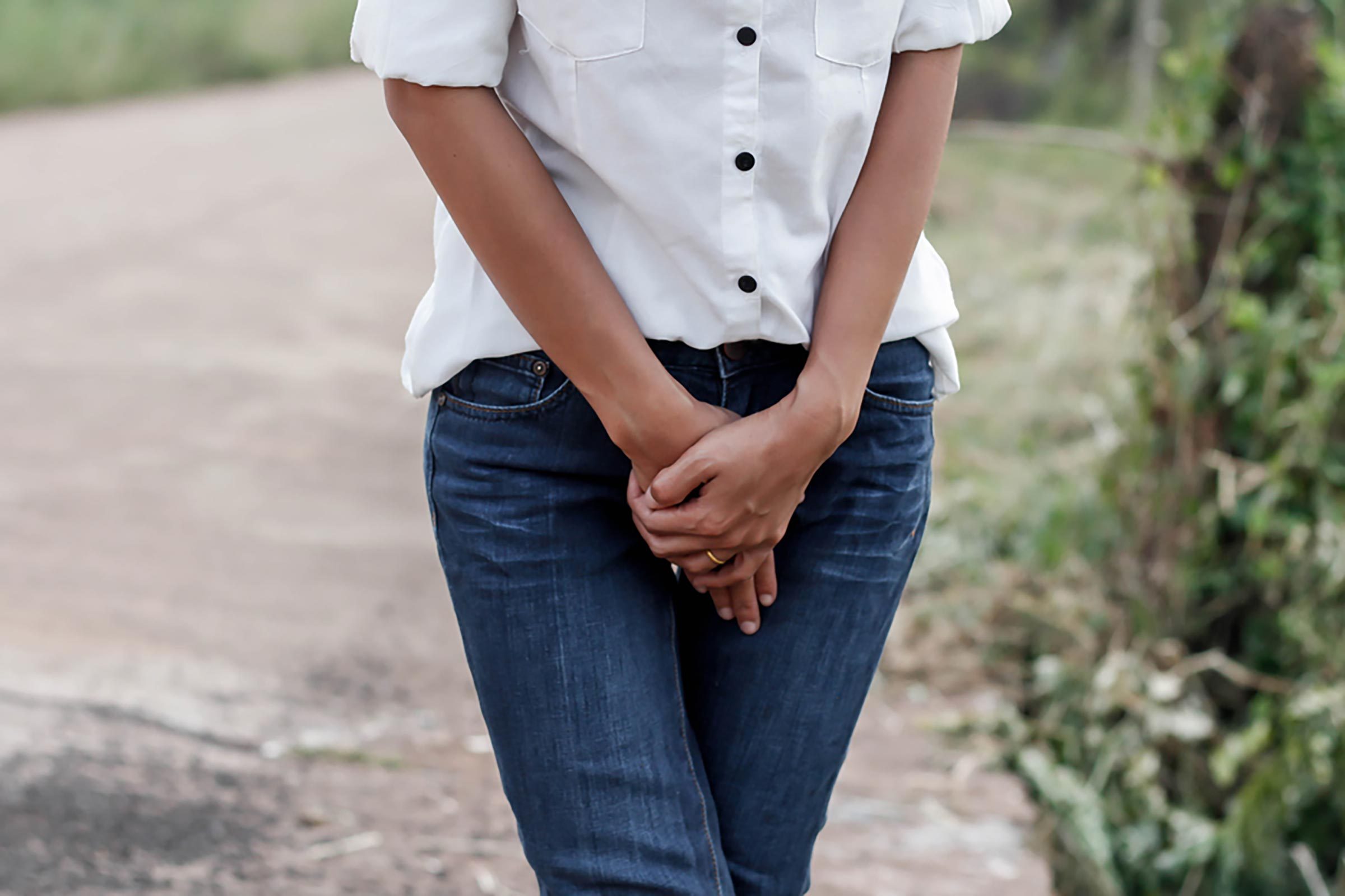 woman's torso with hands below waist