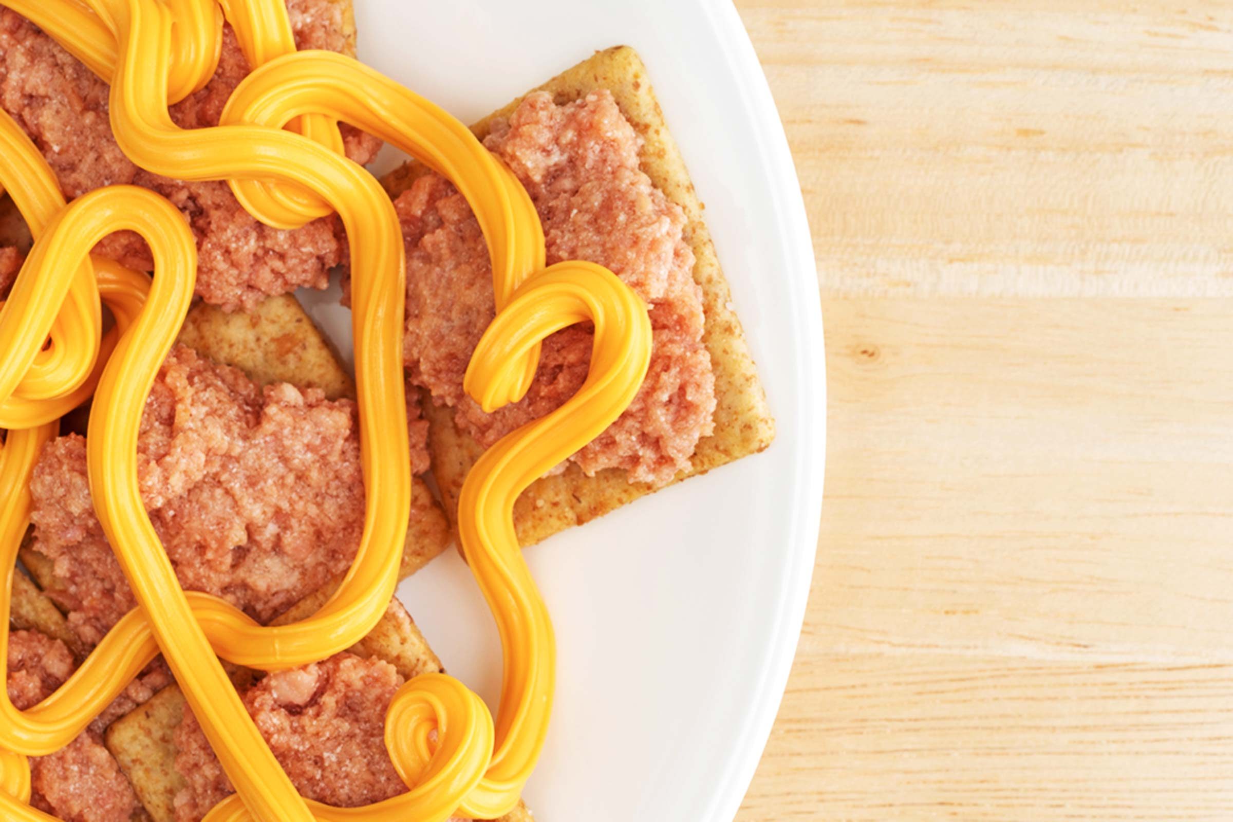 Crackers with streams of cheese wiz