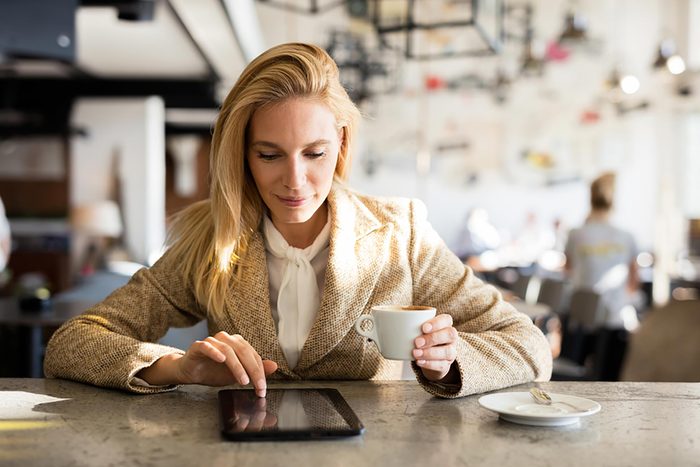 woman in coffee shop on ipad