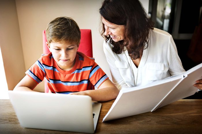 Woman helping boy with homework