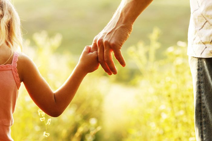 man holding little girl's hand