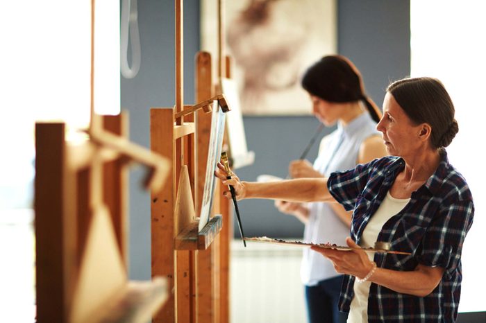 people painting in a class