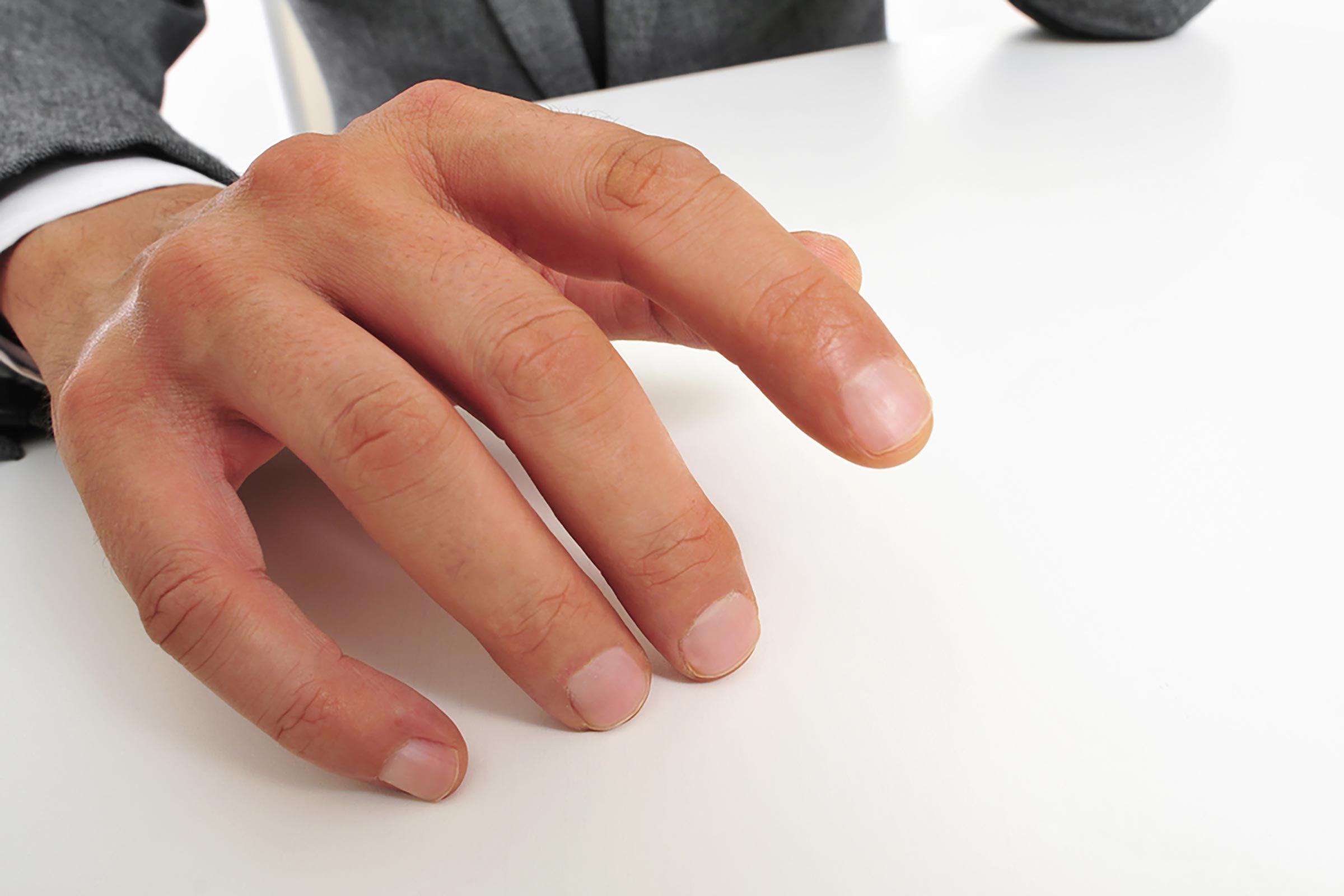 business man drumming his fingers on a table