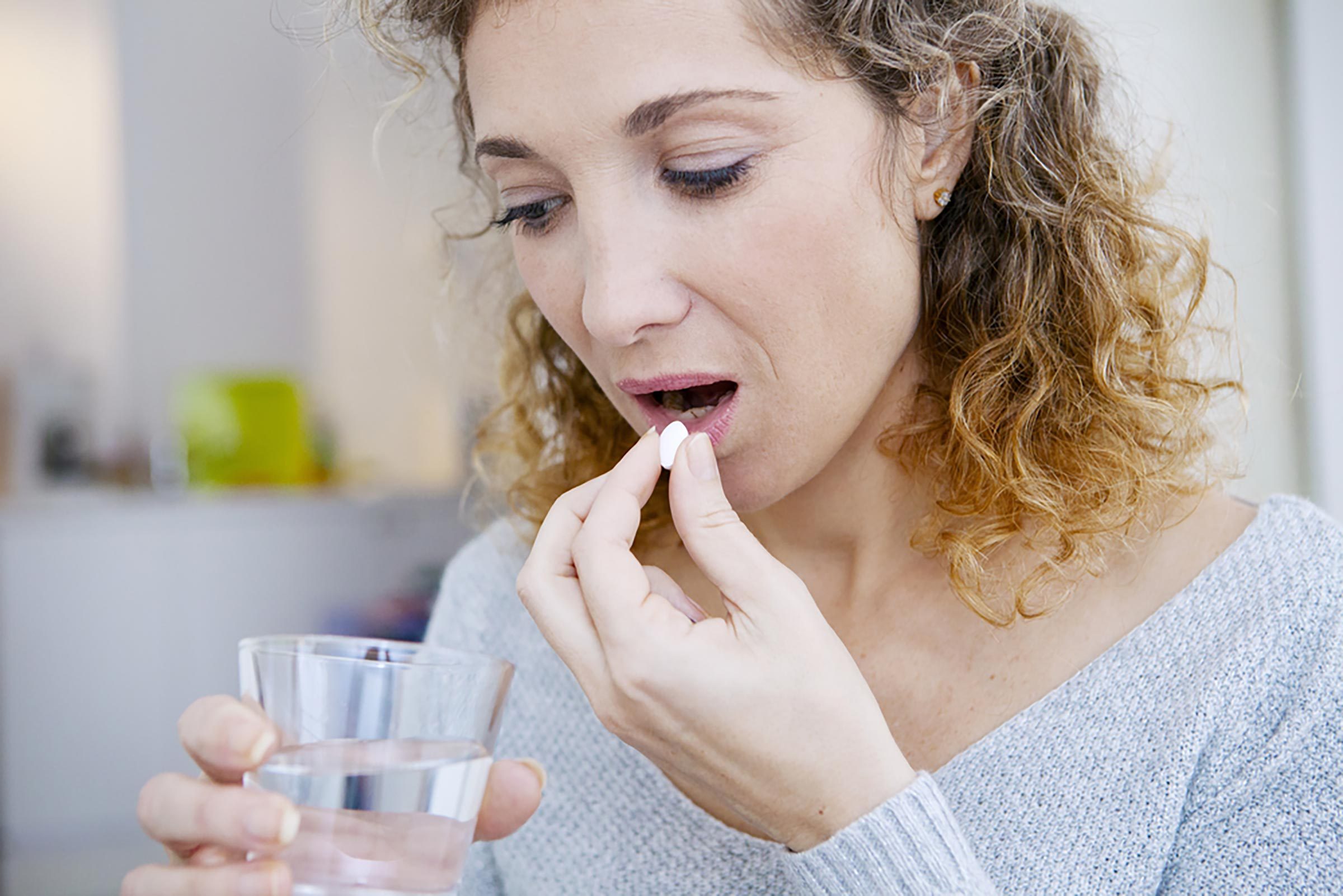 woman taking medication