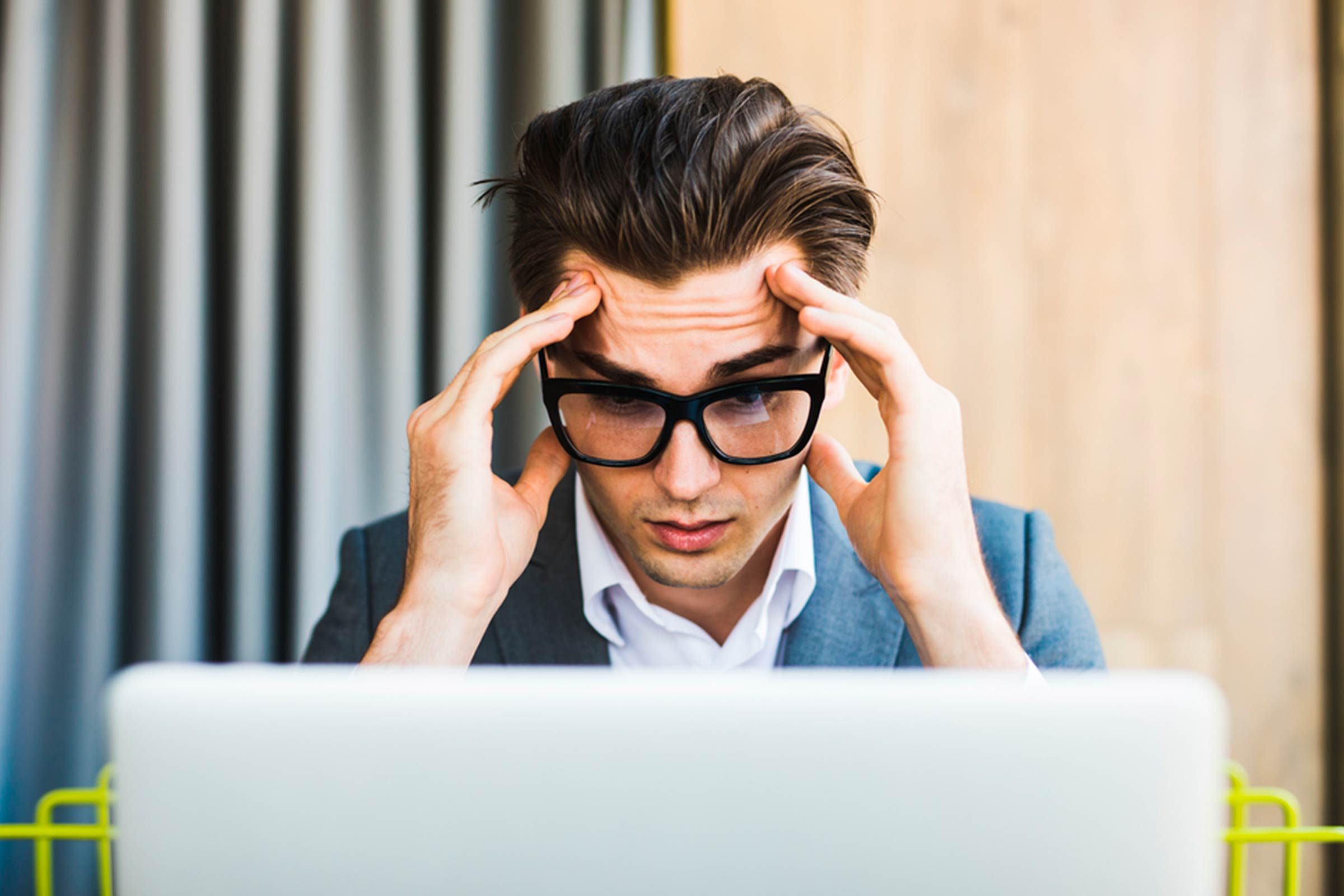 man in glasses at computer