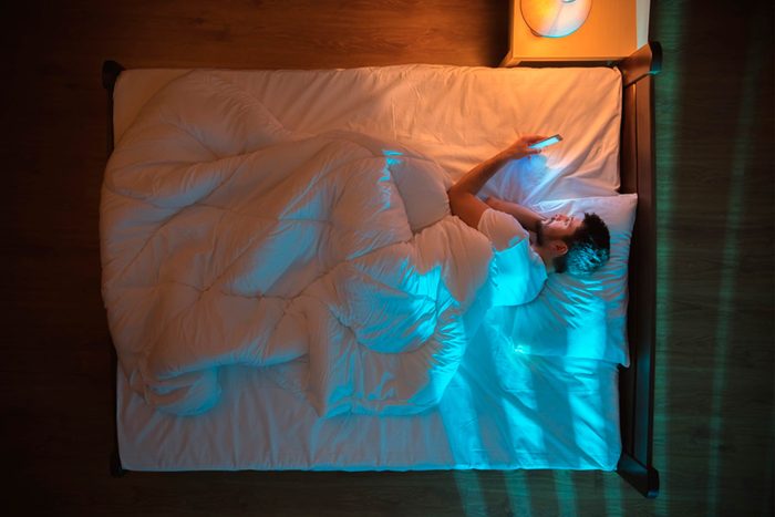 man with insomnia in bed