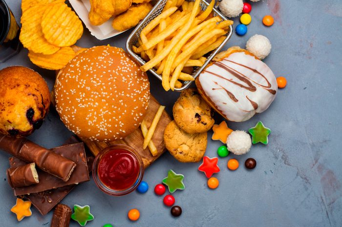 An array of junk food, including candy, cookies, chips, and fries.