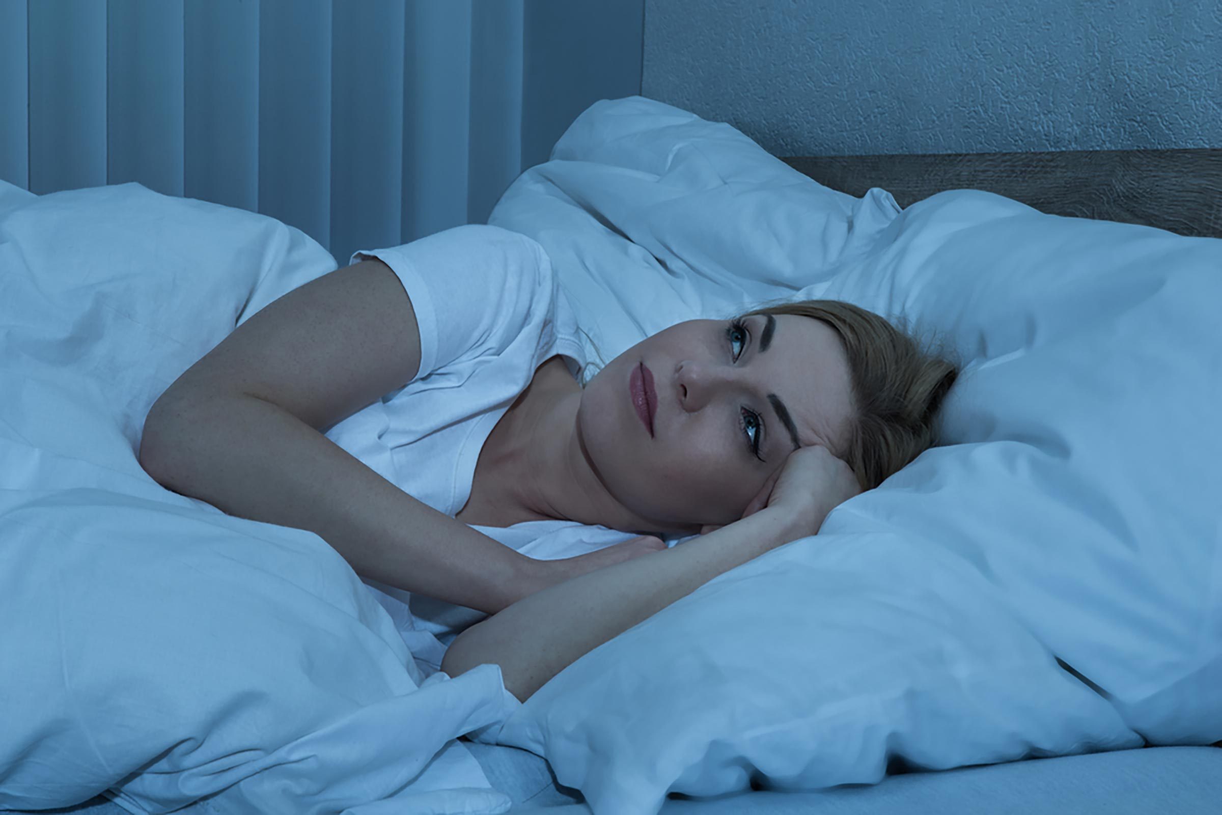 woman lying awake in bed