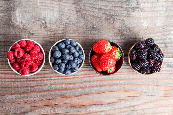 Ramekins of raspberries, blueberries, strawberries, and blackberries.