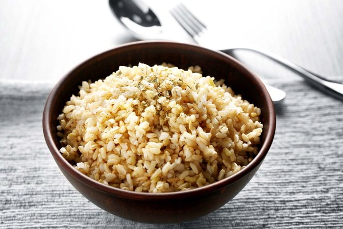 wooden bowl full of seasoned brown rice
