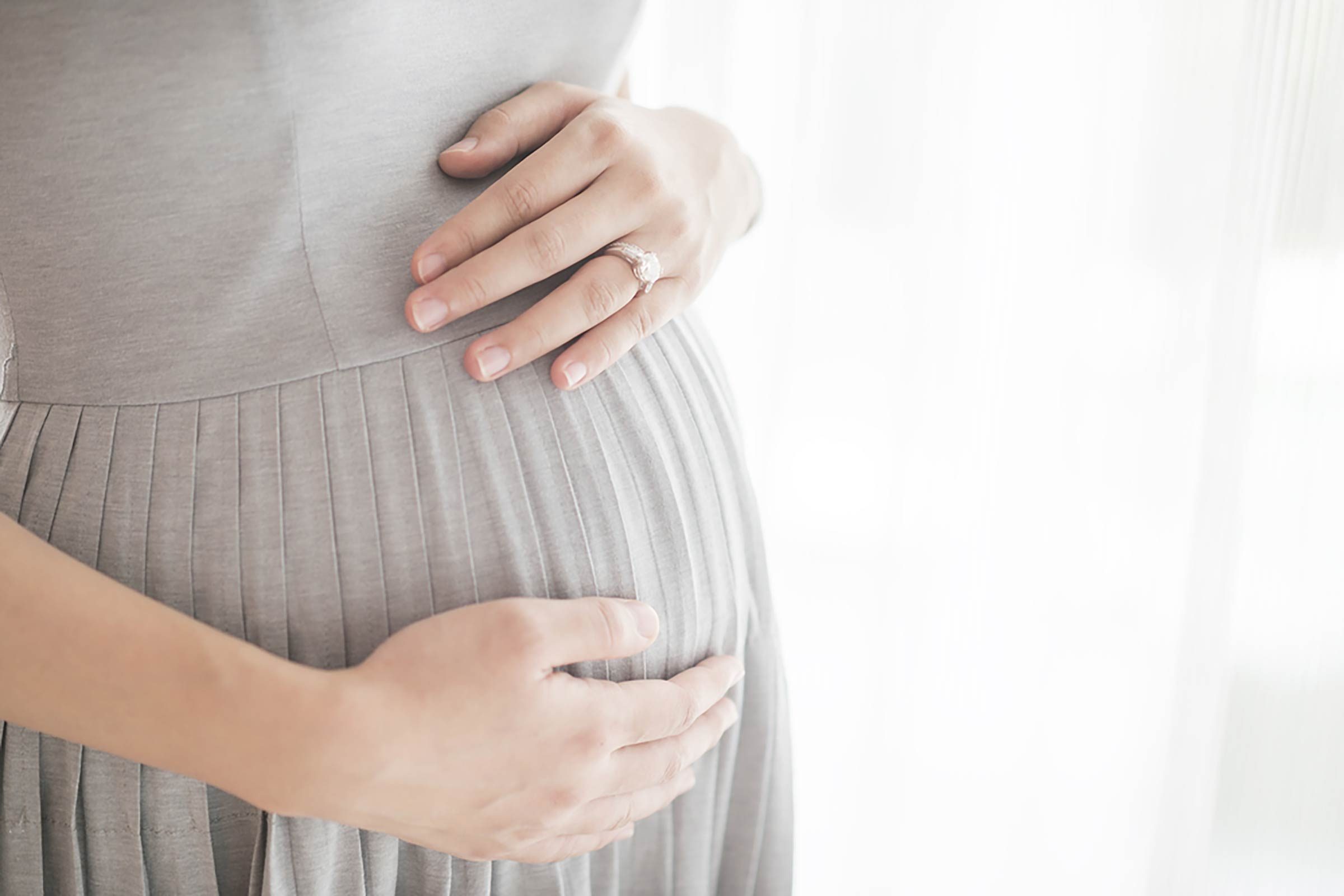 pregnant woman with hands on stomach