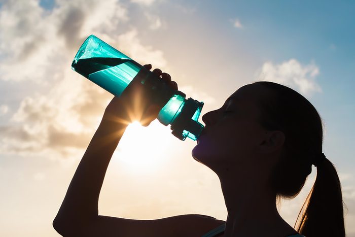 Woman drinking from bottle of water