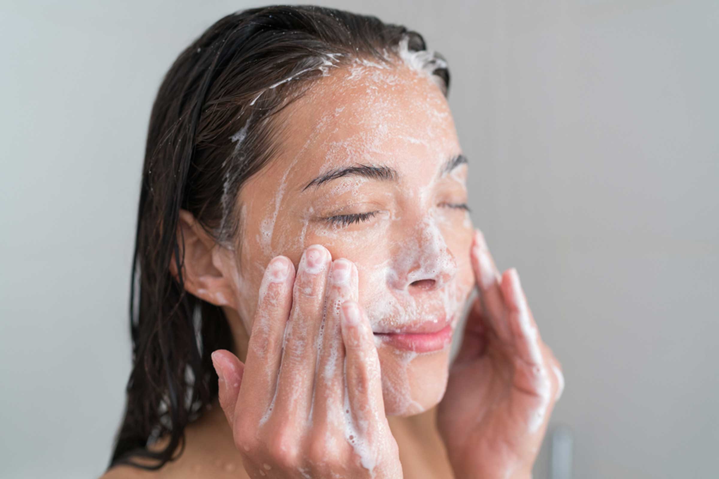 woman washing her face