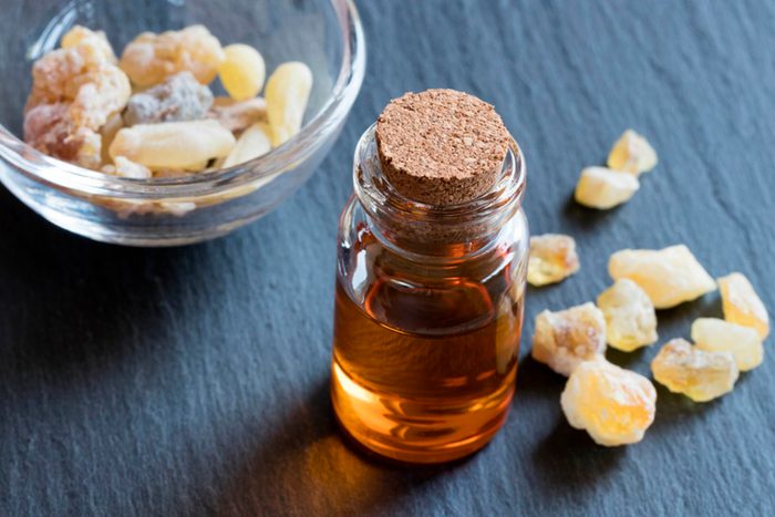 candied ginger on a table with essential oil bottle