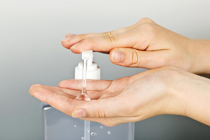 hands pumping sanitizer