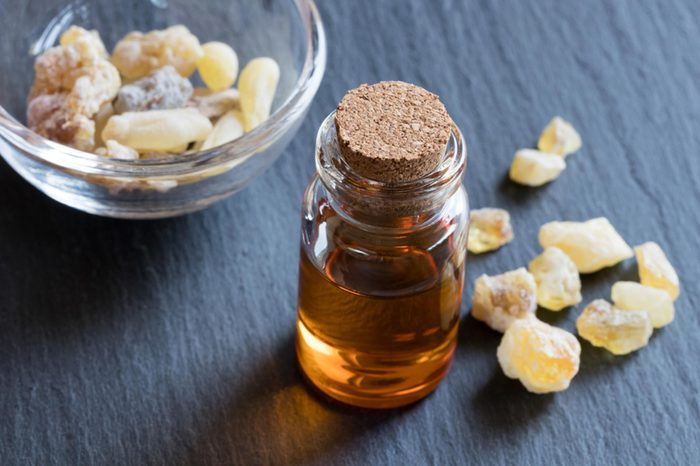 frankincense oil in small glass bottle topped with cork