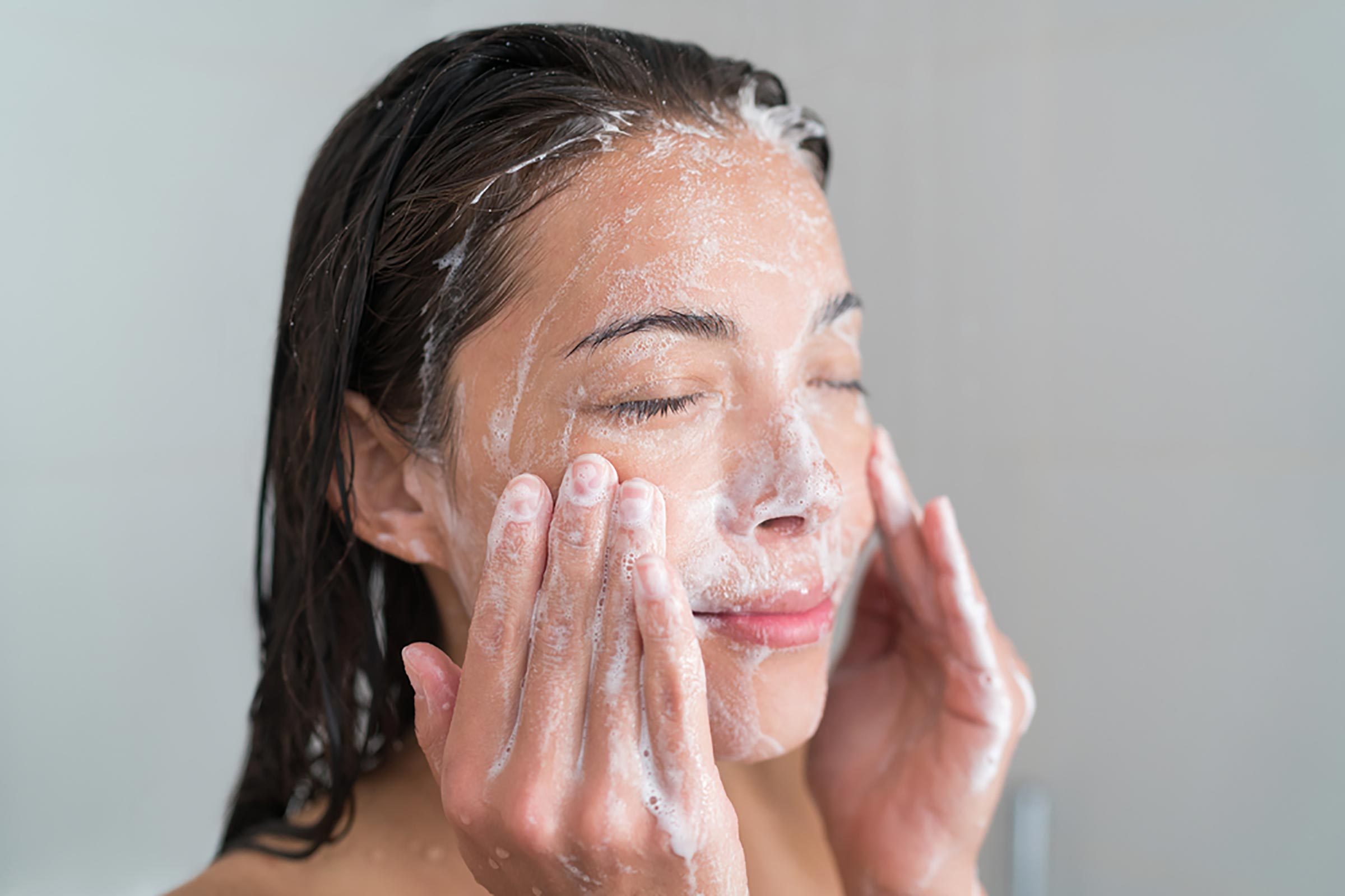 woman washing her face