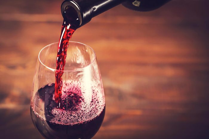 red wine pouring into a glass