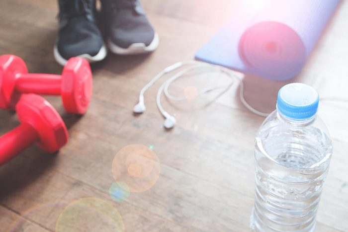dumbbells, running shoes, bottled water, ear buds