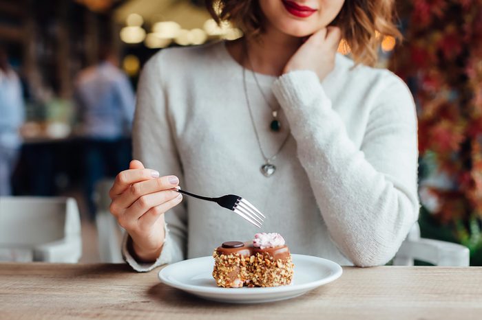 woman at a restaurant eating dessert