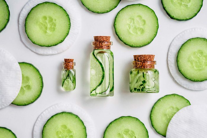 Cucumber slices artfully arranged around jars containing cucumber liquid