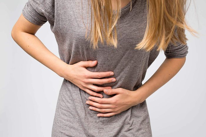 Woman holding her stomach in pain