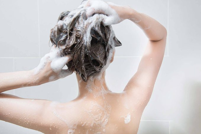Woman shampooing her hair in the shower.