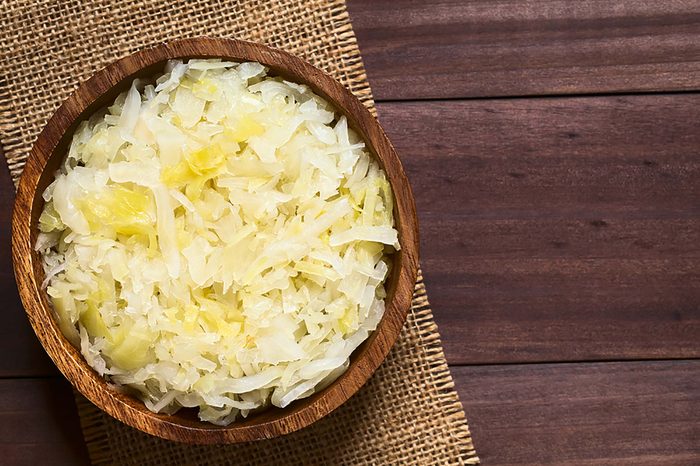 Bowl of sauerkraut on a wooden table.