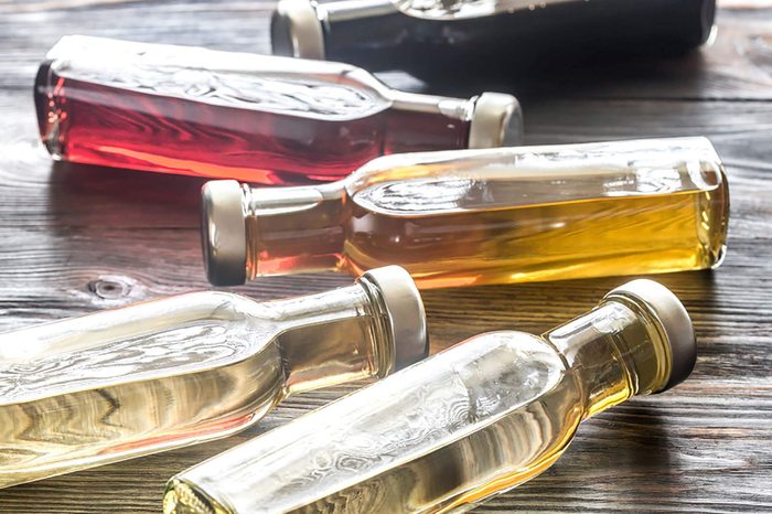 Bottles of different-color vinegar on a table