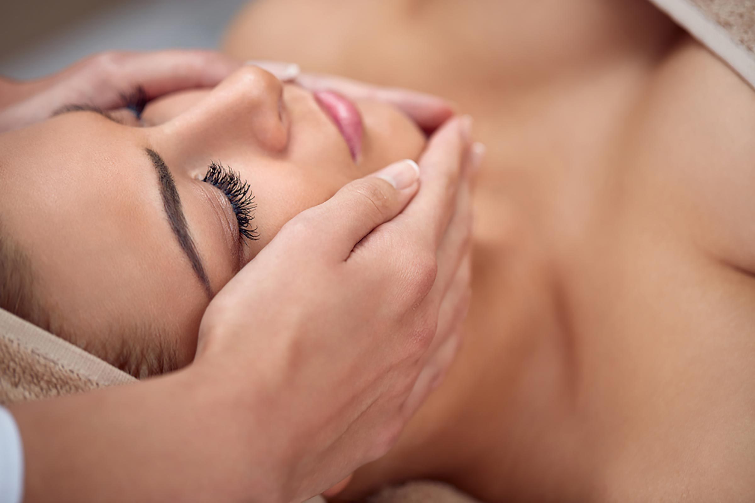 woman having her face massaged