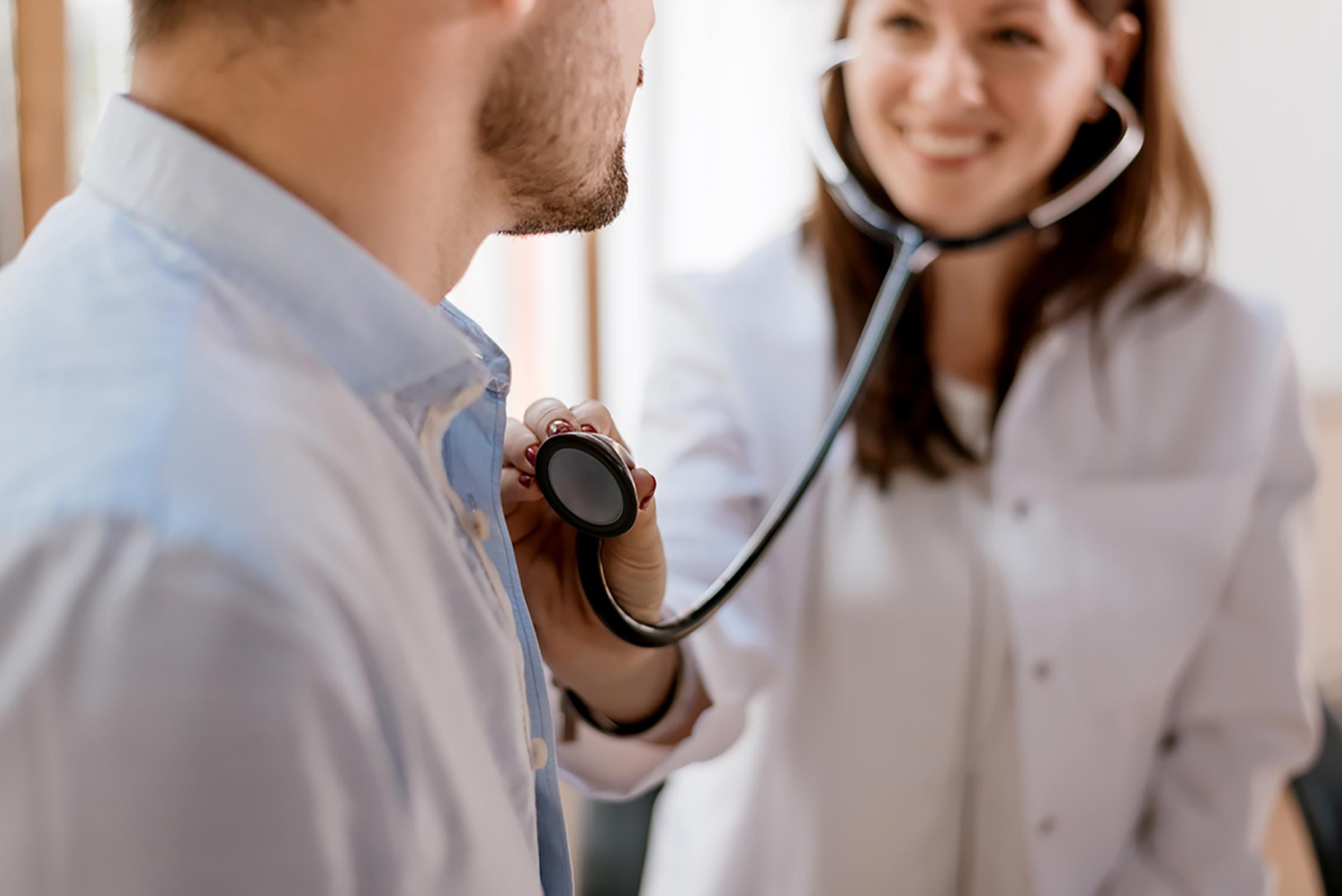 doctor listening to patient's heart