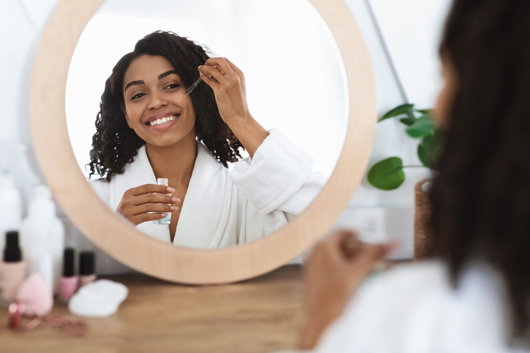 woman applying serum to face