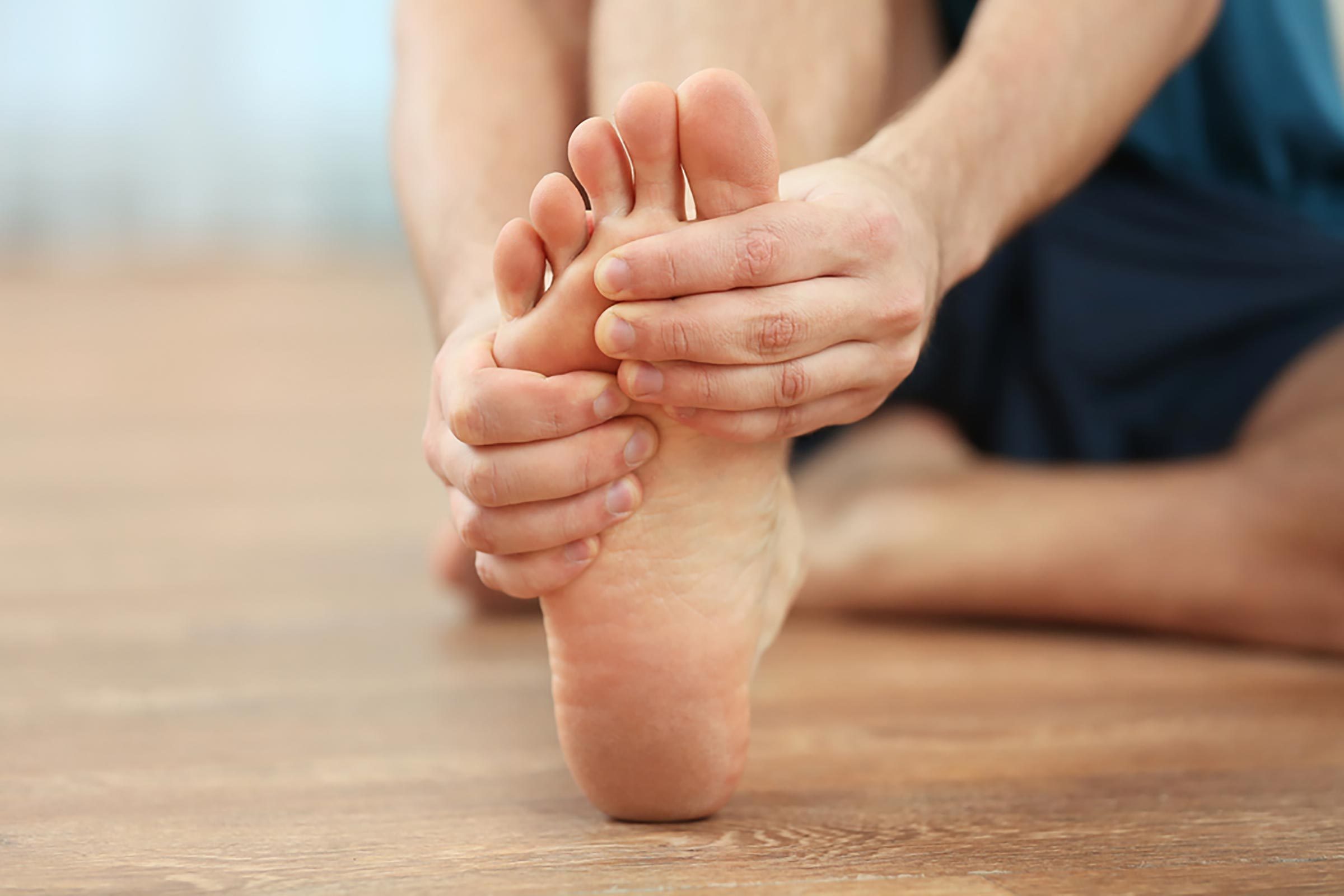 a person massaging his foot