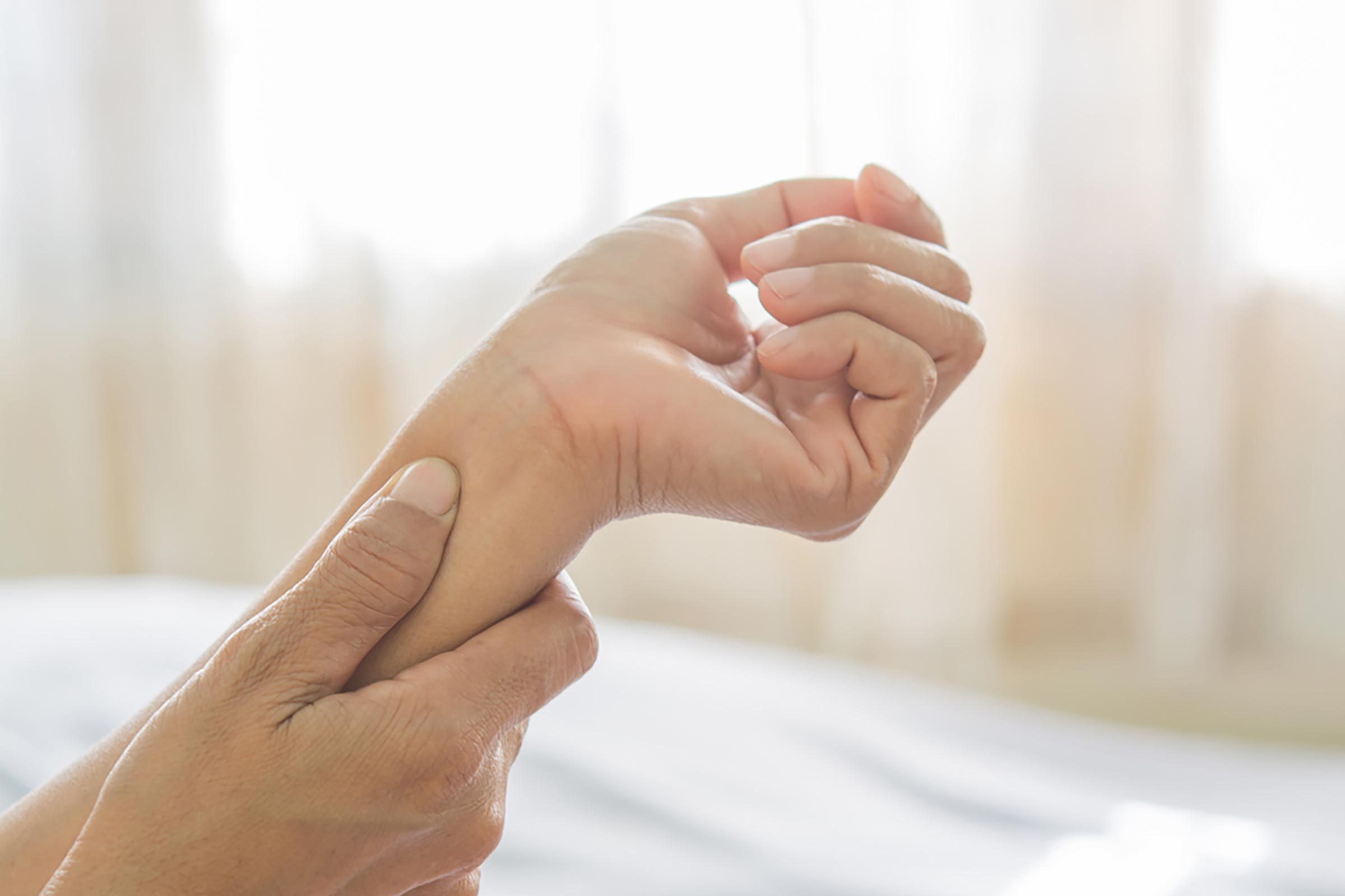 closeup of a person holding her wrist